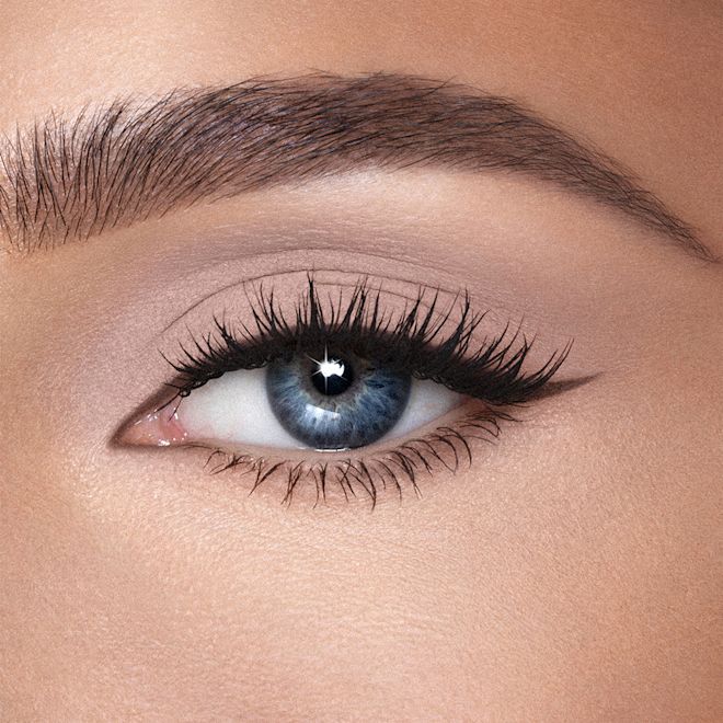 Matte Eyes to Mesmerise in Nude Cashmere on blue eyes close-up Single-eye close-up of a light-tone model with blue eyes wearing a soft taupe cream eyeshadow with a matte finish.