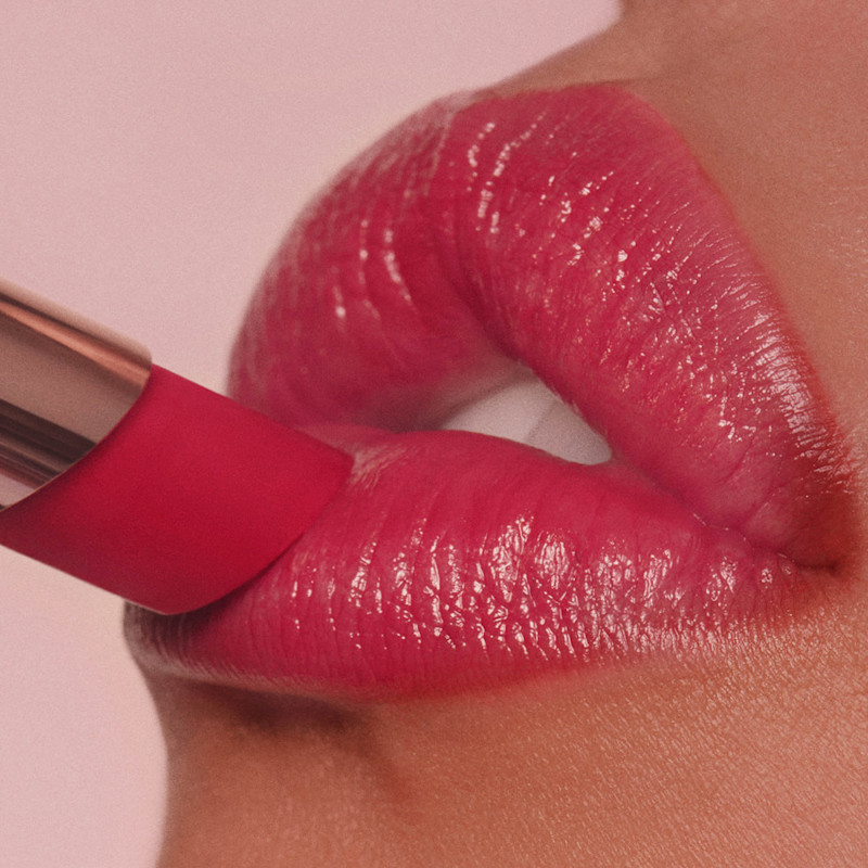 Cherry Talk lip tint on tan skin close up