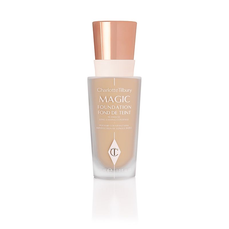 A foundation in a light beige-coloured frosted bottle with a rose-gold coloured metallic lid. 
