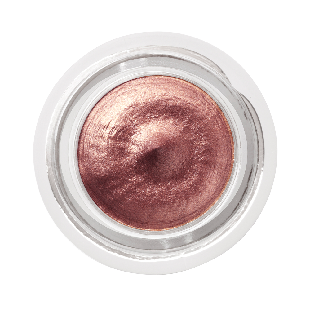 Close-up of a dark rose gold. cream eyeshadow in an open glass pot.