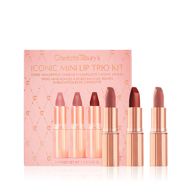 Iconic Mini Lip Trio with packaging displayed Three mini lipsticks in different shades of nude in gold-coloured tubes with a pink-coloured makeup box.