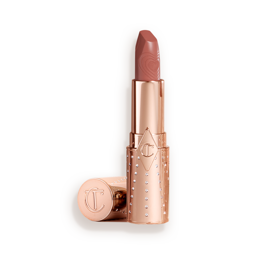 An open, medium-pink satin-finish lipstick in a golden-coloured tube with its lid next to it.