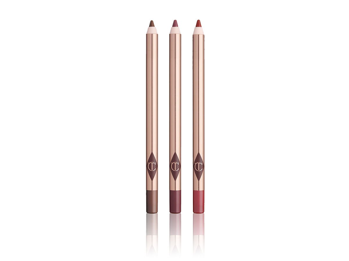 An open, lip liner trio in taupe-brown, nude pink, and berry pink shades. 