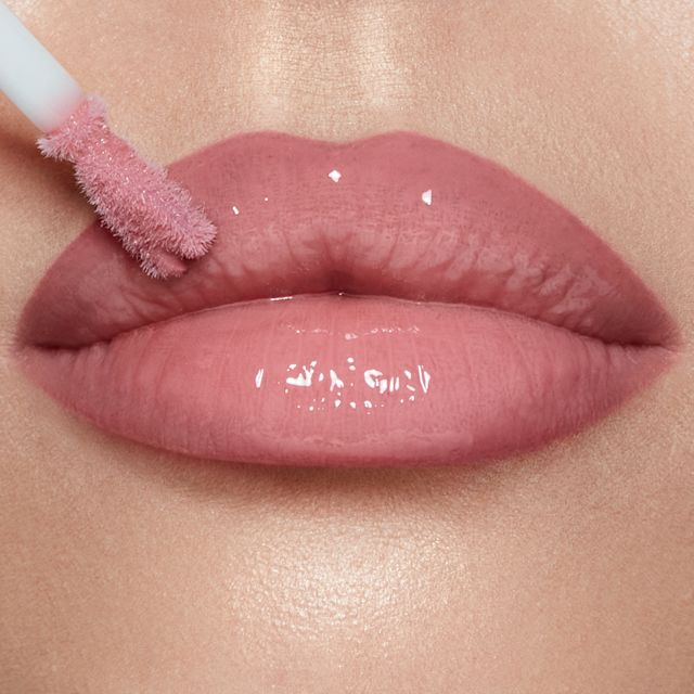 Model wearing Pillow Talk Fair Collagen Lip Bath cool-pink lip gloss