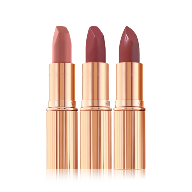 Three open matte lipstick in nude pink, berry-pink, and berry-rose shades in metallic, golden-coloured packaging. 