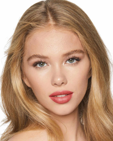 Fair-tone model with grey eyes wearing a rusty rose-coloured lipstick with a moisturising, satin-finish.