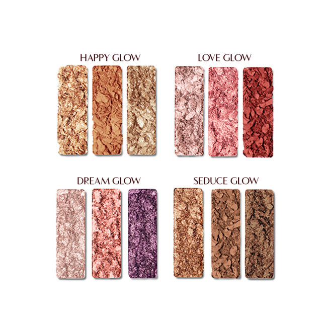 Instant Eye Palette swatches Swatches of twelve matte and shimmery eyeshadow palettes in shades of gold, brown, pink, red, purple, and beige shades.