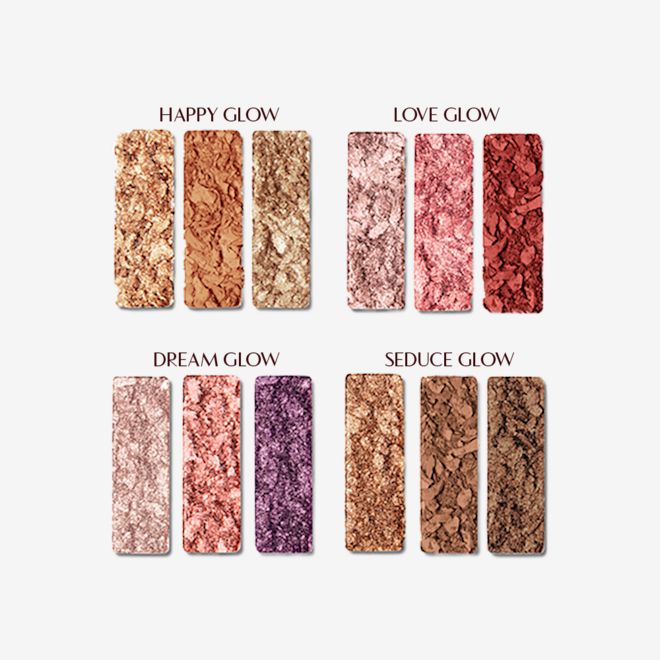 Instant Eye Palette swatches Swatches of twelve matte and shimmery eyeshadow palettes in shades of gold, brown, pink, red, purple, and beige shades.