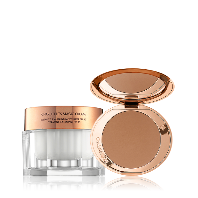 An open, mirrored-lid bronzer compact in a medium-brown shade with a thick, pearly-white face cream in a glass jar and rose-gold lid. 