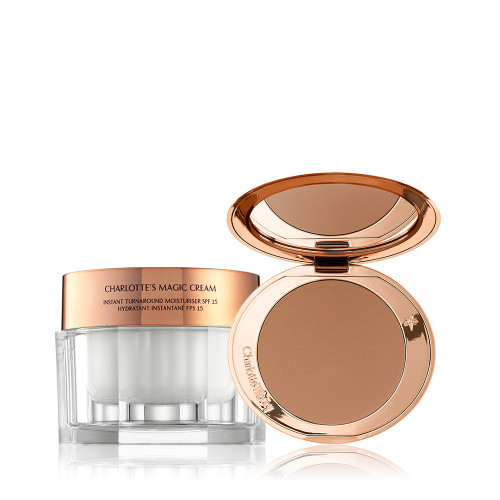 An open, mirrored-lid bronzer compact in a medium-brown shade with a thick, pearly-white face cream in a glass jar and rose-gold lid. 