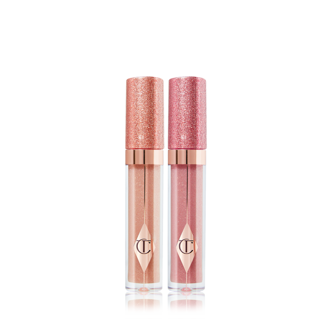 Two shimmery lip glosses, in shades of dark champagne and nude pink with glass tubes and glittery lids.