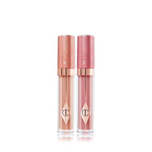 Two shimmery lip glosses, in shades of dark champagne and nude pink with glass tubes and glittery lids.