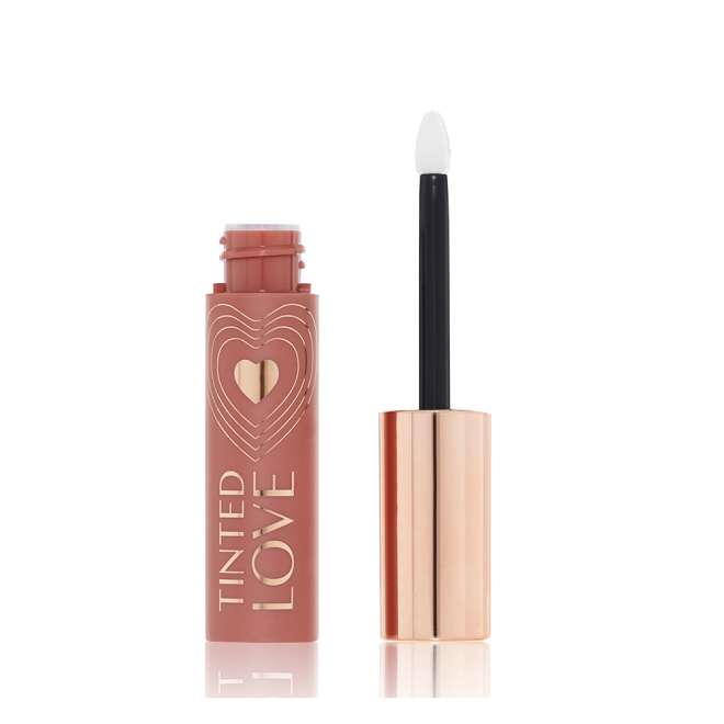 An open lip and cheek tint with a gold-coloured lid in a soft nude brown-coloured tube.