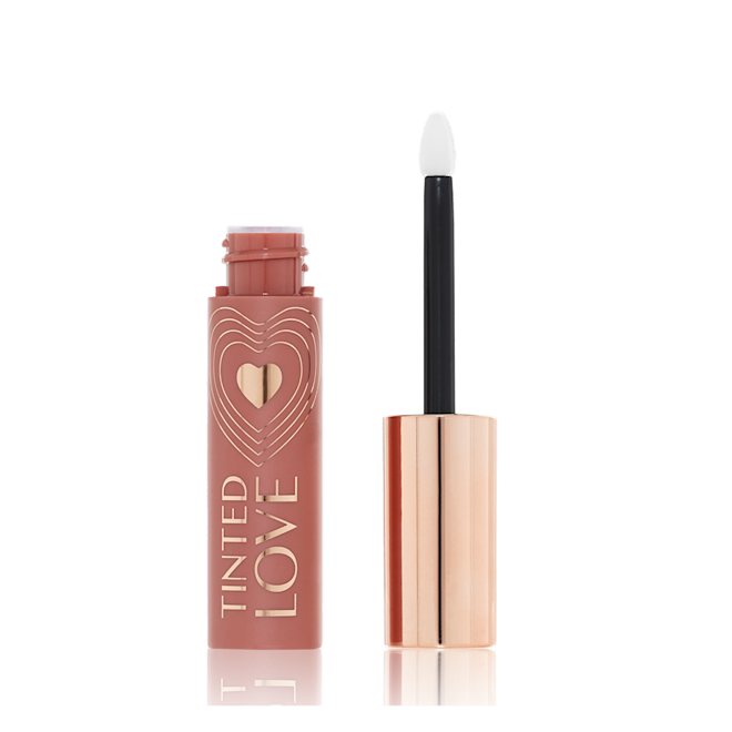 Tinted Love in Santa Euphoria open An open lip and cheek tint with a gold-coloured lid in a soft nude brown-coloured tube.