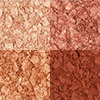 Swatches of four, matte and shimmery eyeshadows in shades of copper and champagne. 