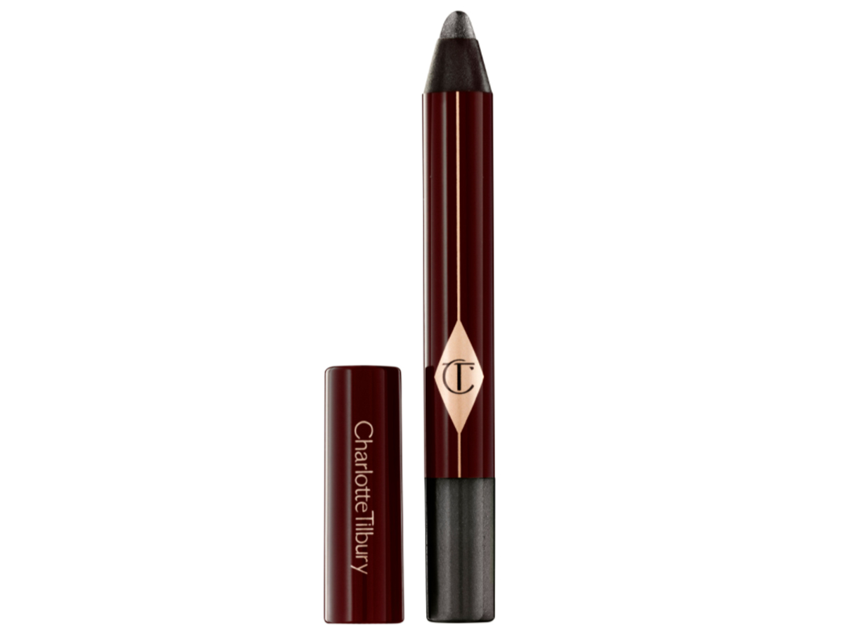 An open, chubby eyeshadow pencil in a shimmery black shade with its lid next to it. 