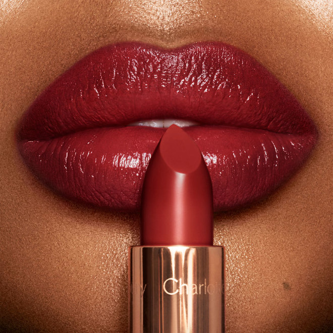 Close-up of a fair-tone model wearing a deep winter berry red lipstick with a satin finish.