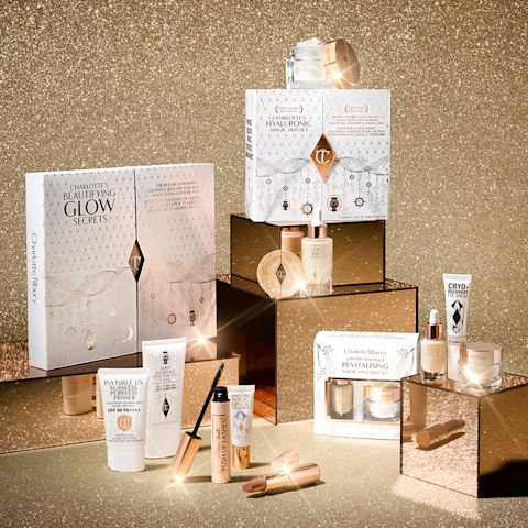 A collection of skincare and makeup sets in white and golden-coloured packaging. 