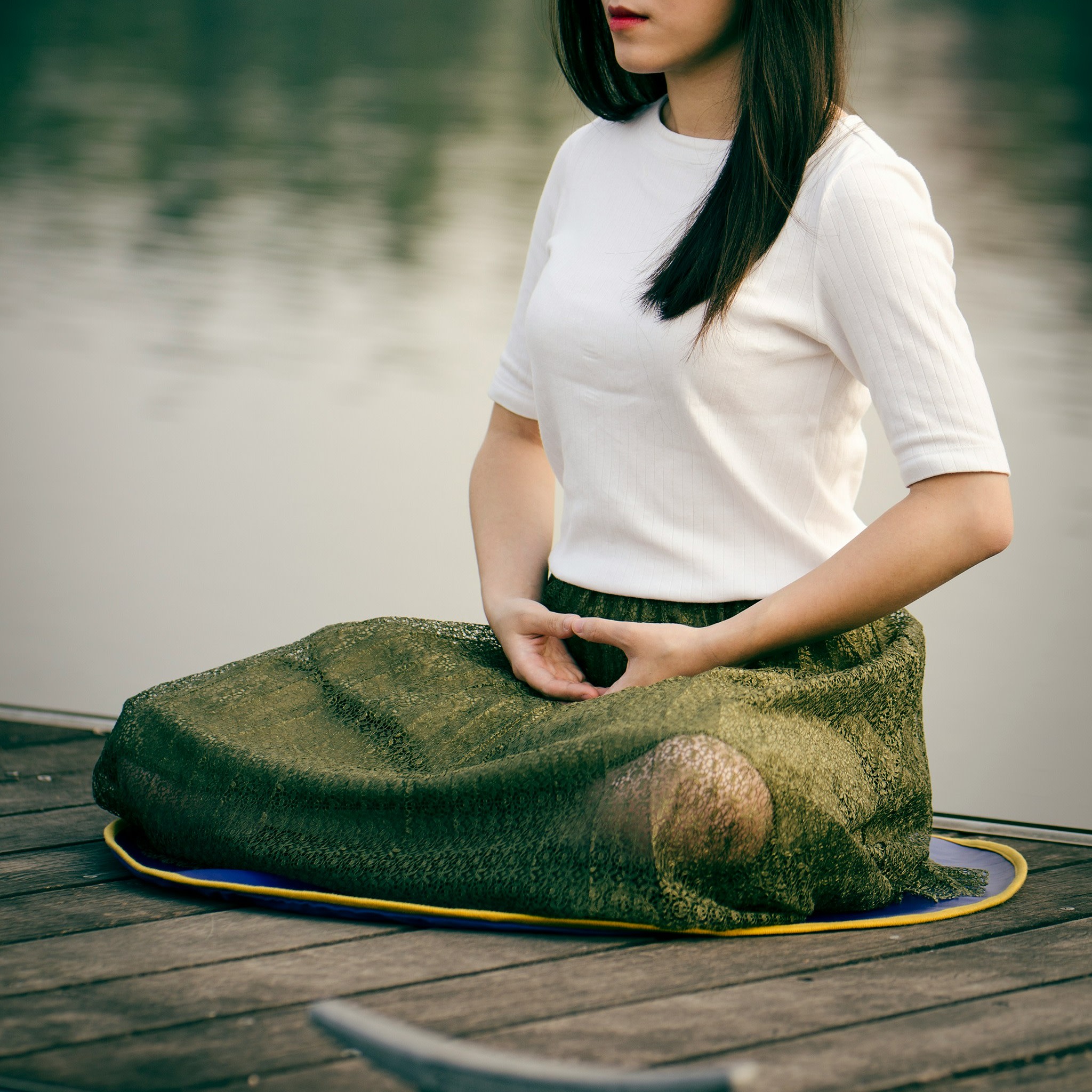 Model sat meditating and using breathing techniques 