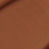 Close-up swatch of a skin-like, glowy foundation in a black-like brown shade.
