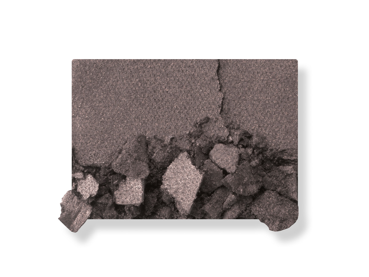 Swatch of a powder eyeshadow in a deep charcoal-grey colour. 