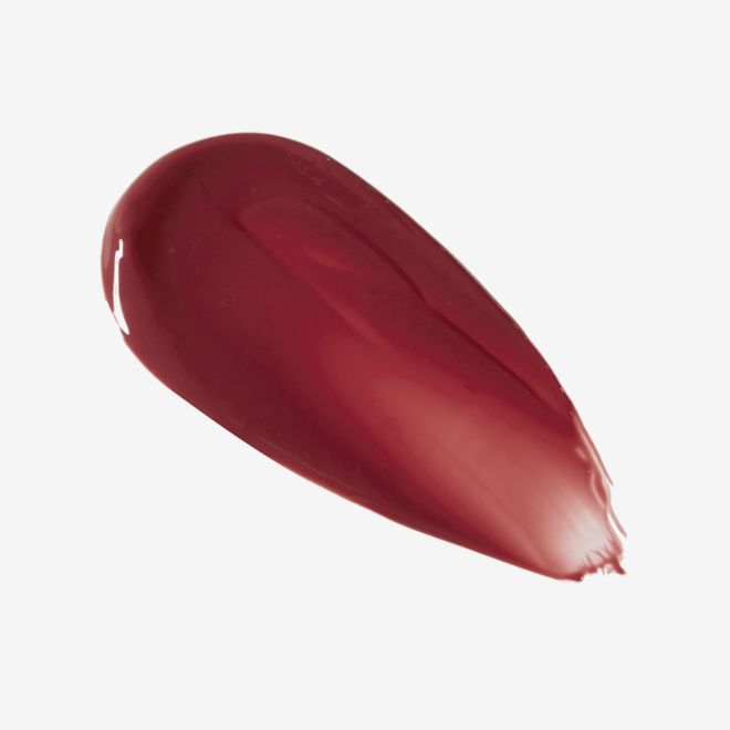 Tinted Love in Tripping on Love swatch Swatch of a creamy lip and cheek tint in a dark cherry-red shade.