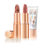 An open nude terracotta lipstick in golden-coloured packaging, open nude pink matte lipstick in golden-coloured packaging, and lip oil in a white-coloured tube with a reflective, geometrical pattern on the front.