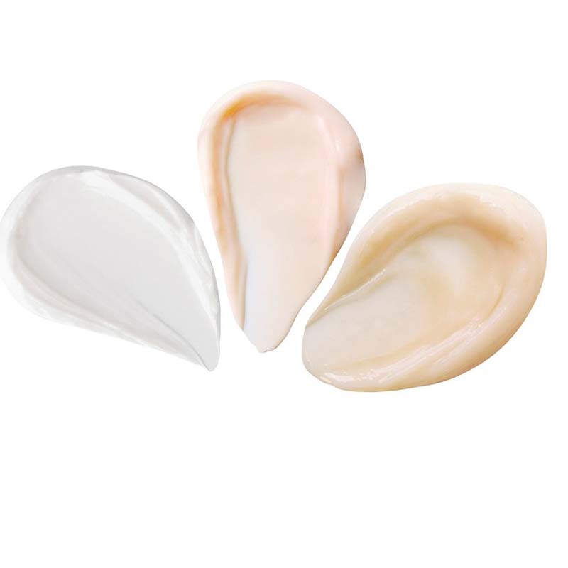 Banner with swatches of a pearly-white face cream, thick and luscious champagne-coloured night cream, and peach-coloured eye cream.