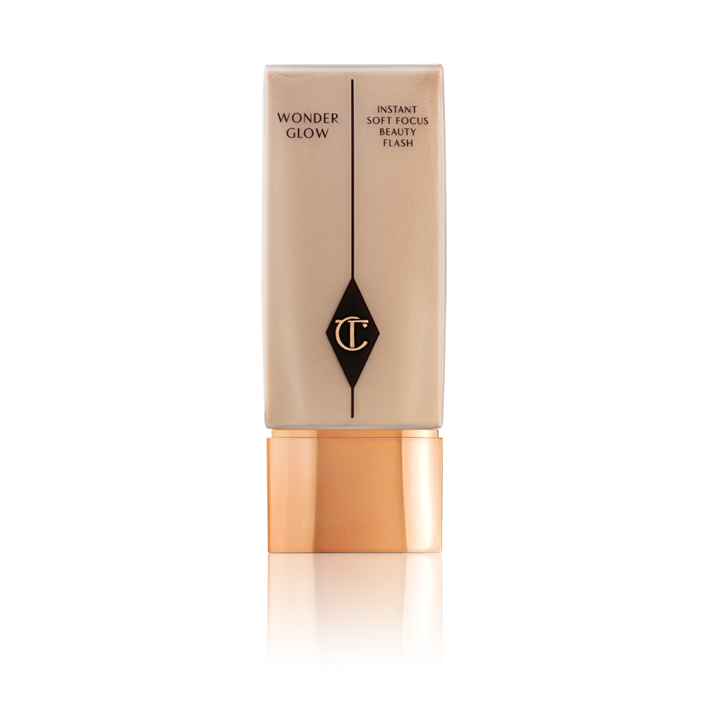 A glowy soft, rose-gold-coloured primer in a sleek rectangular bottle with a gold-coloured lid. 