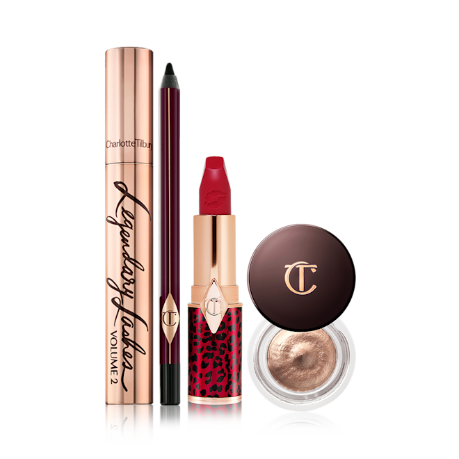 Mesmerising Holiday Eye and Lip Look displayed Black mascara in a gold-coloured tube, eyeliner pencil in a black colour, bold red lipstick, and cream eyeshadow in a petite pot with a dark brown-coloured serum.