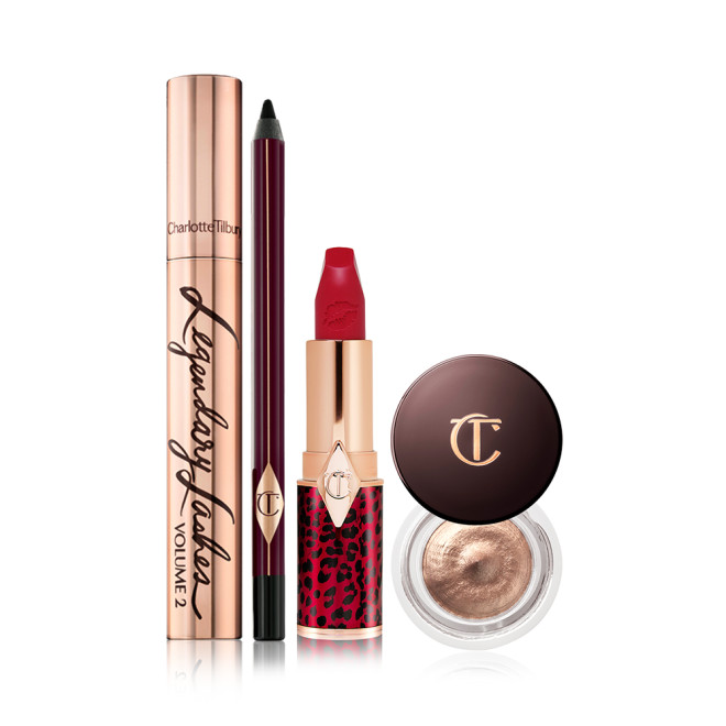 Black mascara in a gold-coloured tube, eyeliner pencil in a black colour, bold red lipstick, and cream eyeshadow in a petite pot with a dark brown-coloured serum.