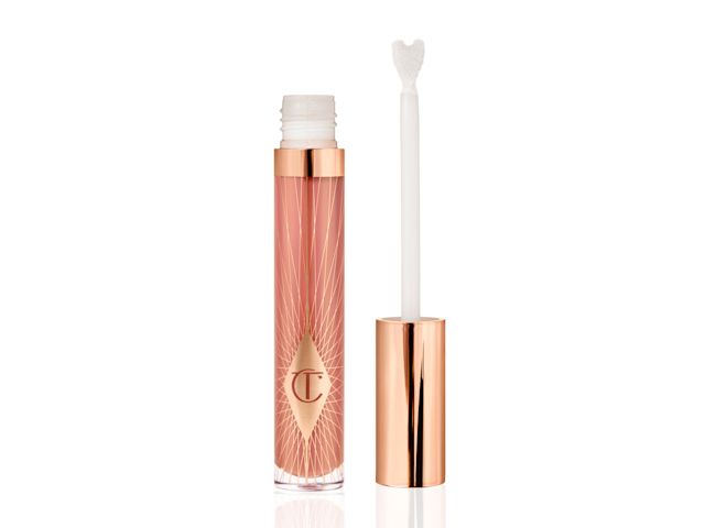 A nude pink lip gloss with its heart-shaped applicator next to it.