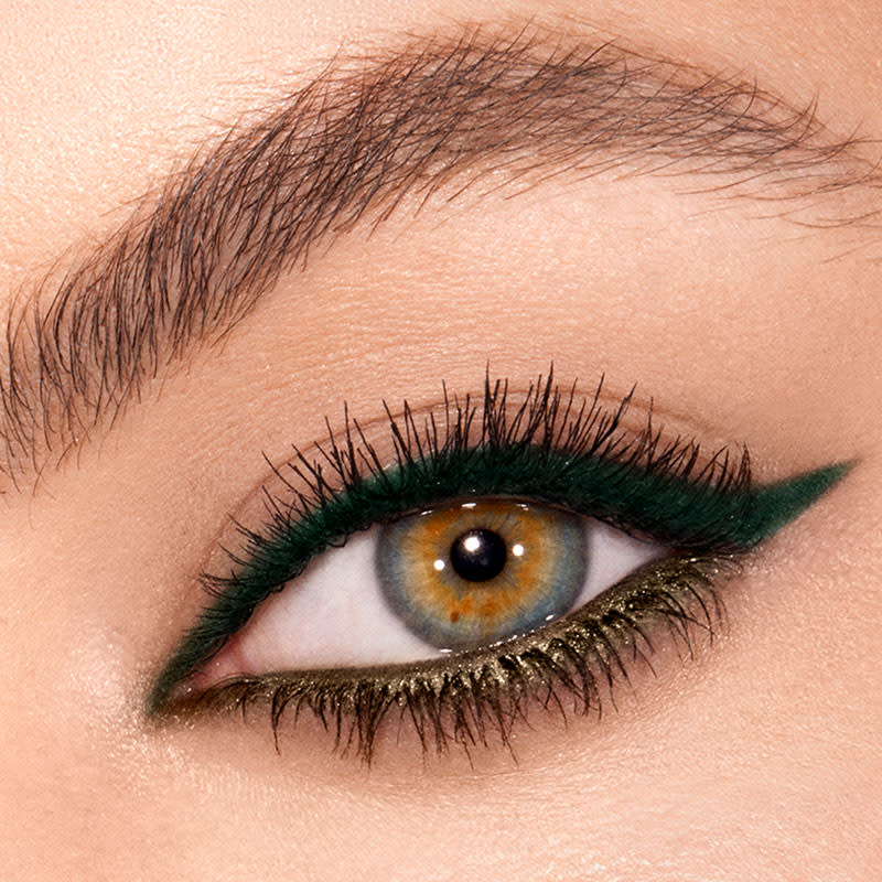 Eye close-up of hazel eyes wearing a matte bottle green eyeliner on upper lid and metallic khaki-coloured eyeliner on lower waterline. 