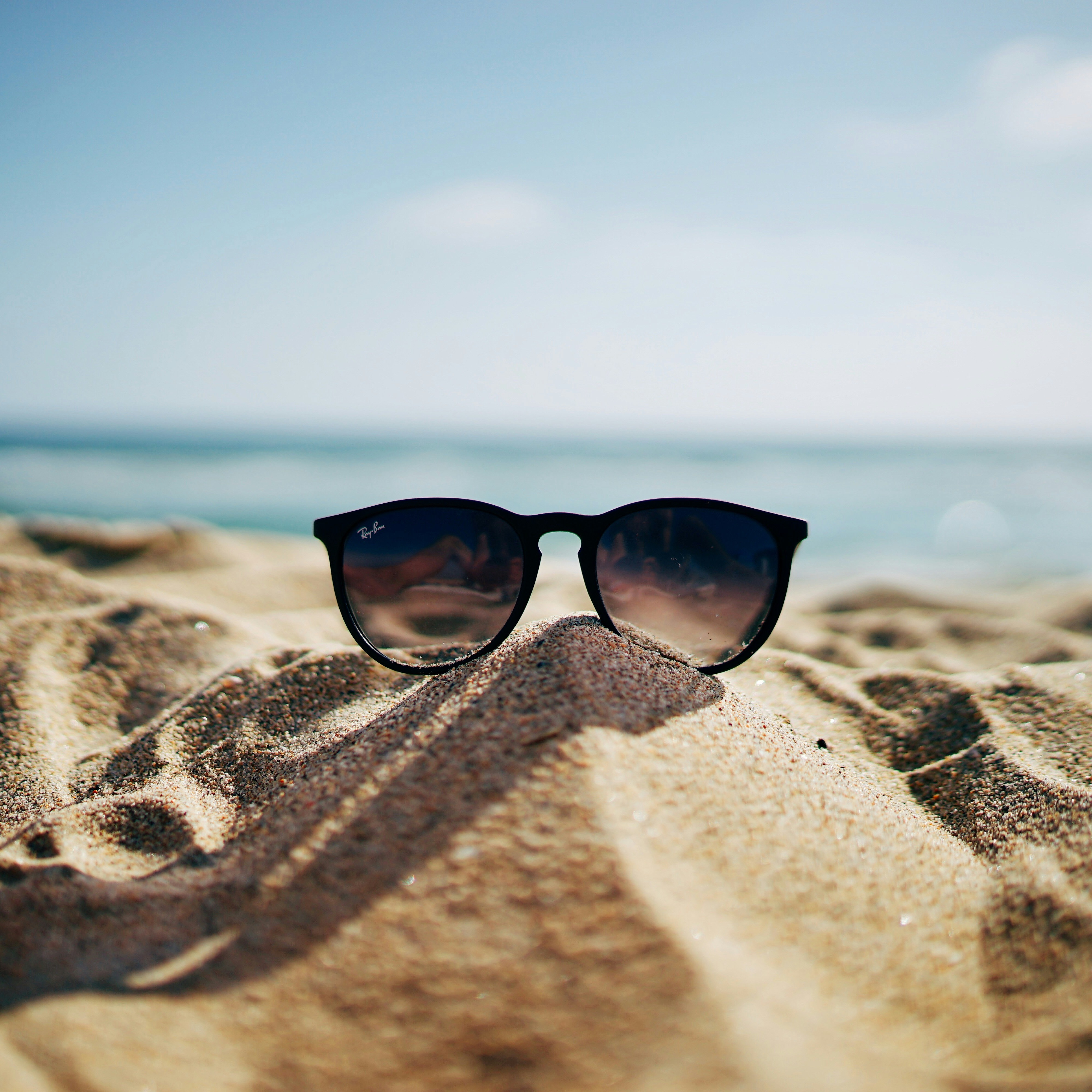 Sunglasses in the sand on a stress-free holiday