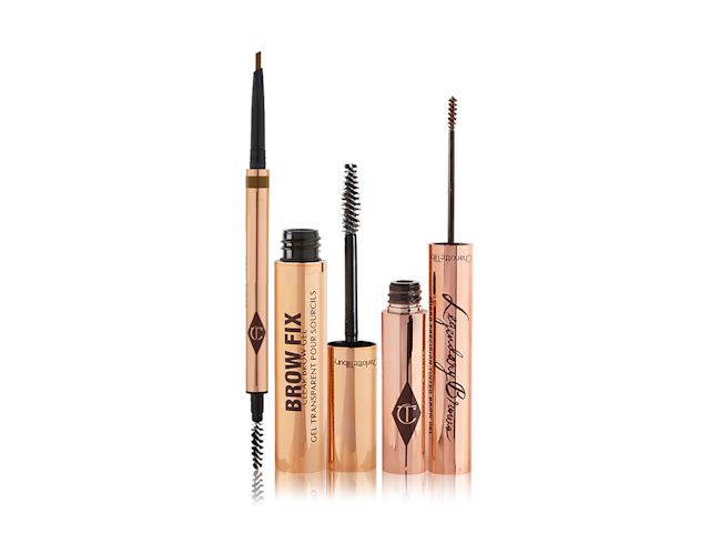 An open, double-ended eyebrow pencil and eyebrow brush with gold-coloured packaging, eyebrow gel in a gold-coloured tube, and eyebrow tint with a thin brush for precision in a rose-gold-coloured tube.