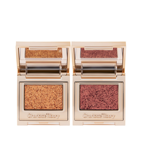 Two, single eyeshadow compacts in gold packaging with mirrored lids in shades of rose gold and duocrome purple.