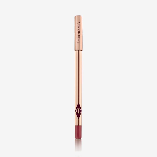 Lip Cheat in Walk of No Shame closed A lip liner pencil in a bold red shade with gold-coloured packaging.