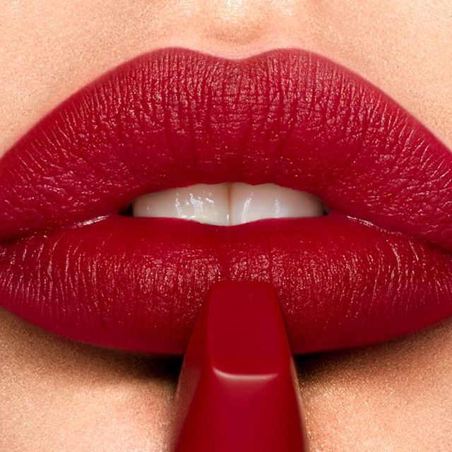 Redheaded model wearing Matte Revolution lipstick in Red Carpet Red