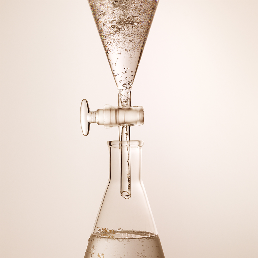 Two laboratory apparatus with a clear hyaluronic acid inside them for testing purpose, which will be used for different skincare products. 