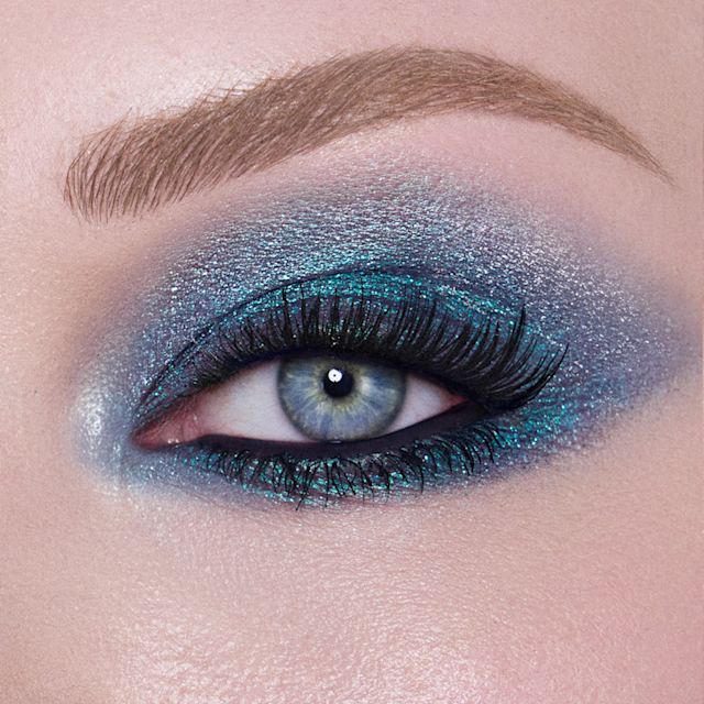 Model eye close up wearing a sparkly blue eyeshadow makeup look using Hypnotising Pop Shot Cosmic Rocks