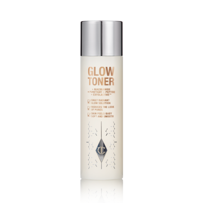 A large, clear bottle filled with luminous, cream-coloured watery toner with a silver-coloured lid.