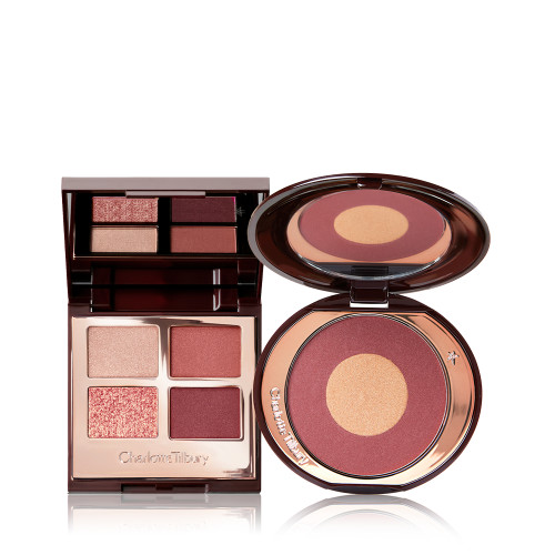An open, quad eyeshadow palette with shades of cranberry and gold with a matching two-tone blush compact with a mirrored-lid.