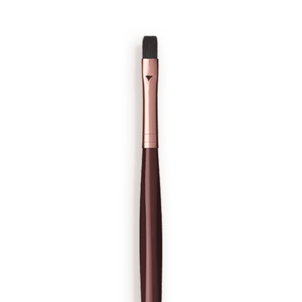 Close-up of a lip brush with a rose-gold and dark crimson handle. 