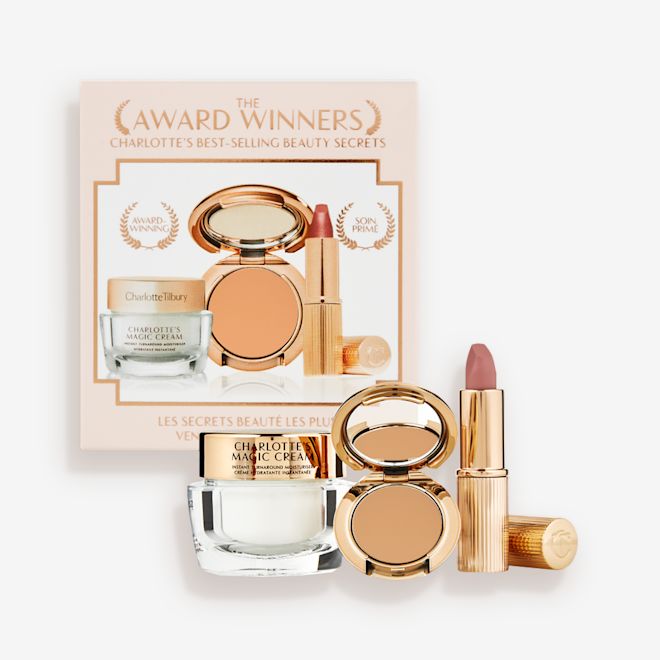 Makeup Starter Kit in Tan displayed Pearly-white face cream in a glass jar with a gold-coloured lid, pressed powder compact in a tan shade, and a dusky pink lipstick in a sleek gold-coloured tube.