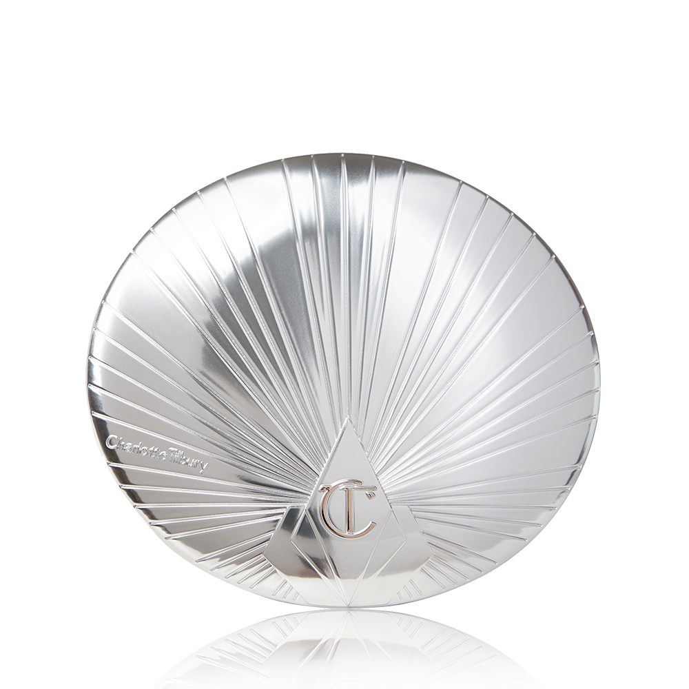 A closed highlighter compact with a silver coloured lid with the CT logo embossed on it. 