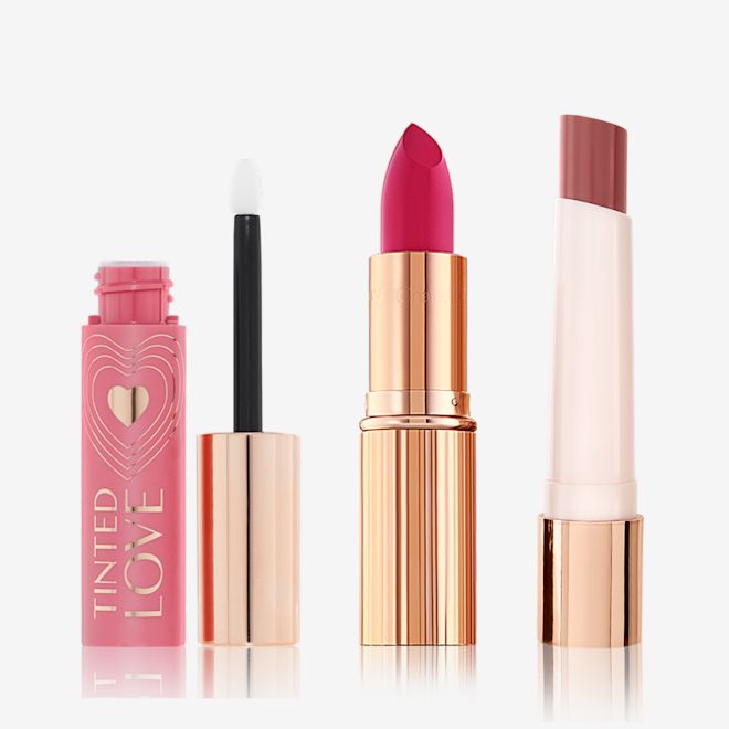 Iconic Lip Secrets Open Lips and cheek tint in petal pink with a doe-foot applicator, lipstick in vivid pink in a sleek, gold-coloured tube, and lipstick balm in a reddish brown shade in white and gold-coloured tube.