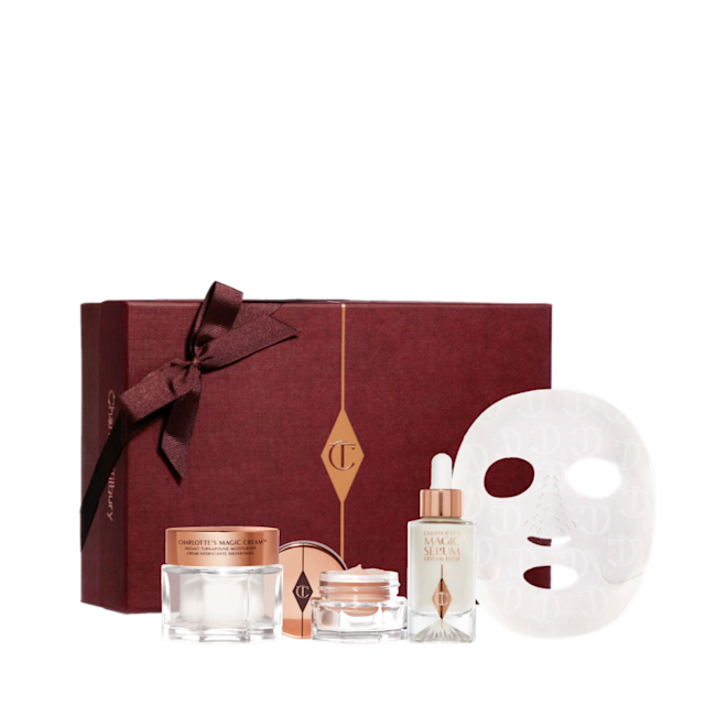 Glowing Night In Box-Bundle-Gift-ox Eye cream in an open glass pot with a gold-coloured lid, dry sheet mask, luminous, ivory-coloured serum in a glass bottle with a white and gold-coloured dropper lid, pearly-white face cream in a glass jar with a gold-coloured lid, along with a light pink-coloured makeup sleeve with text in rose gold on it that reads, 'you are my star. I love you'