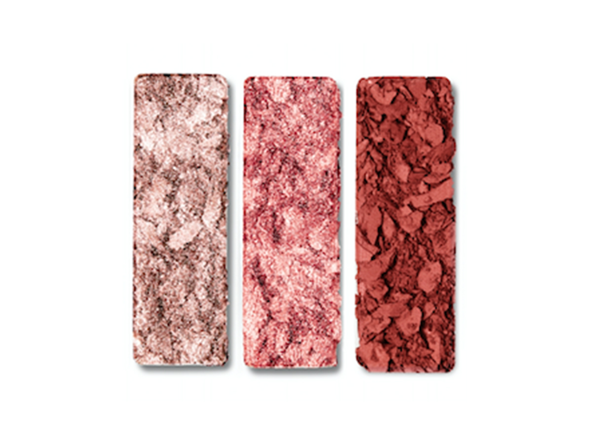 Three shimmery and matte eyeshadows in pinkish ivory, dark rose gold, and rose red colours. 