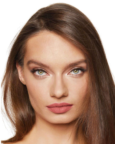 A medium-light-tone model with green eyes wearing shimmery fawn and cream eyeshadow with a warm, peachy-nude matte lipstick.