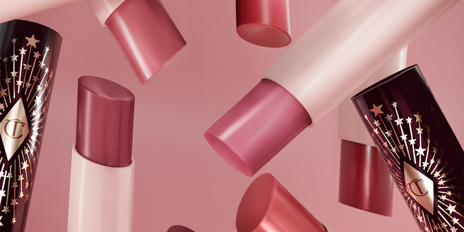 Banner with close-up of different lipstick lip balms in different shades of red, pink, purple, and coral.